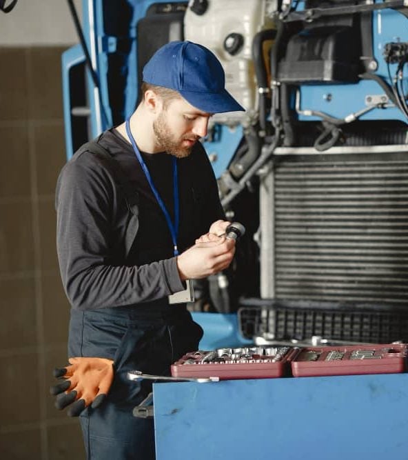 man working on RV engine