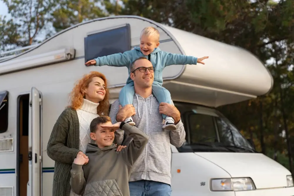 family outside with rv in background