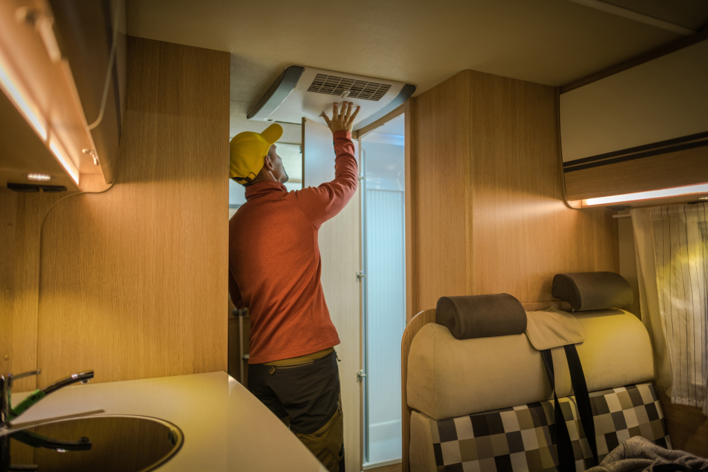 tech working on rv air conditioner