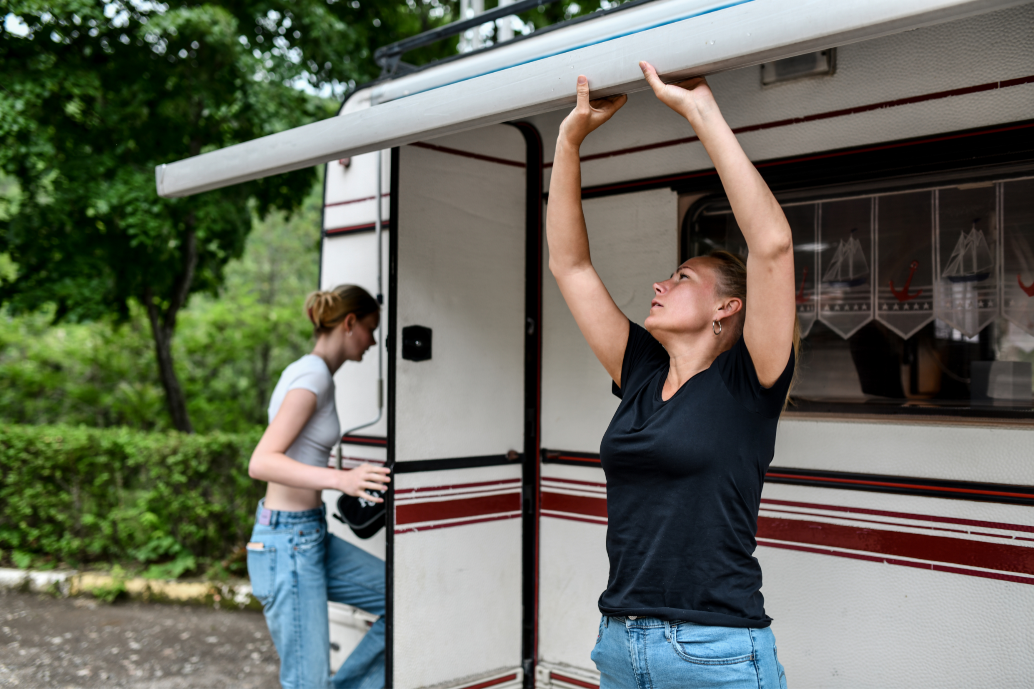 women opening rv awning